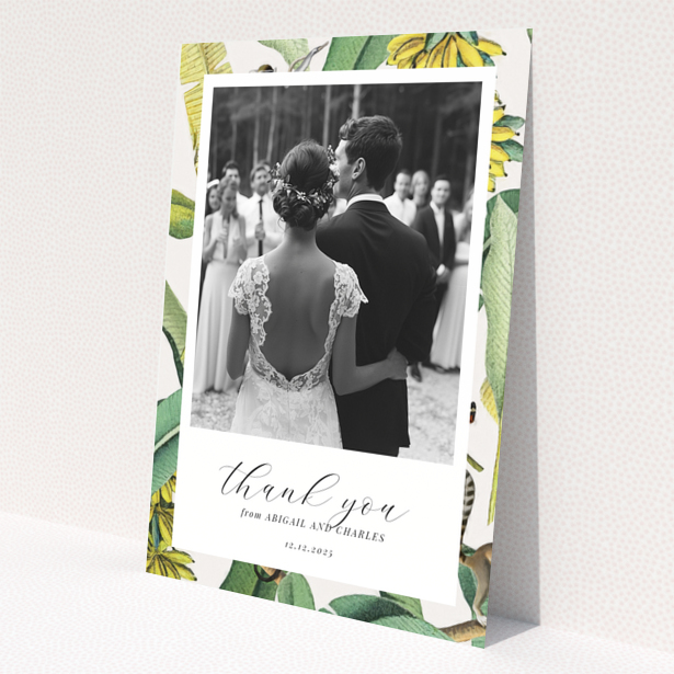 Wedding thank you card with bride and groom, floral border, and one photo.