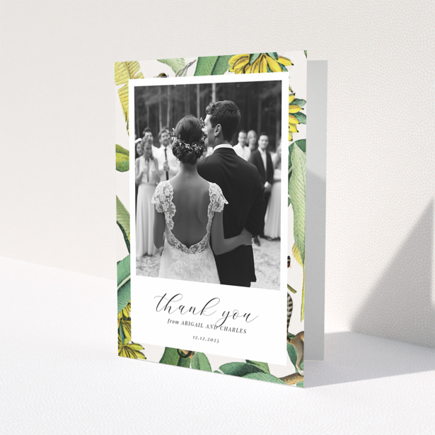 Wedding thank you card with bride and groom, floral border, and one photo.