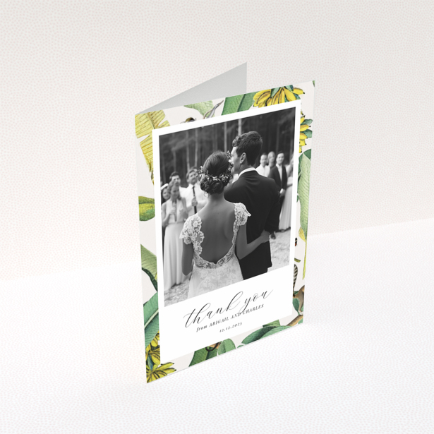 Wedding thank you card with bride and groom, floral border, and one photo.