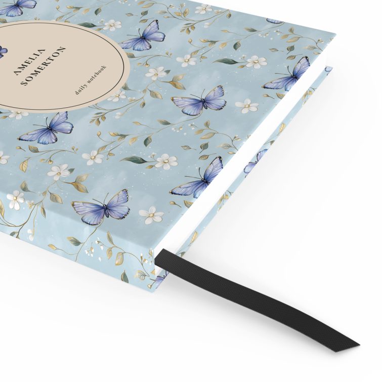 Floral butterfly design daily notebook cover with light blue background and one decorative photo.