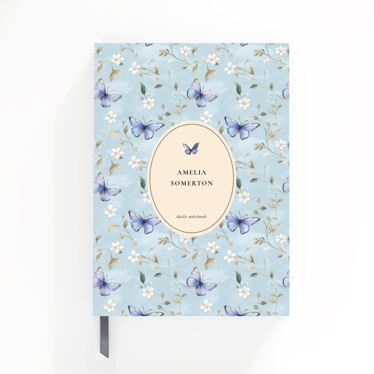 Floral butterfly design daily notebook cover with light blue background and one decorative photo.