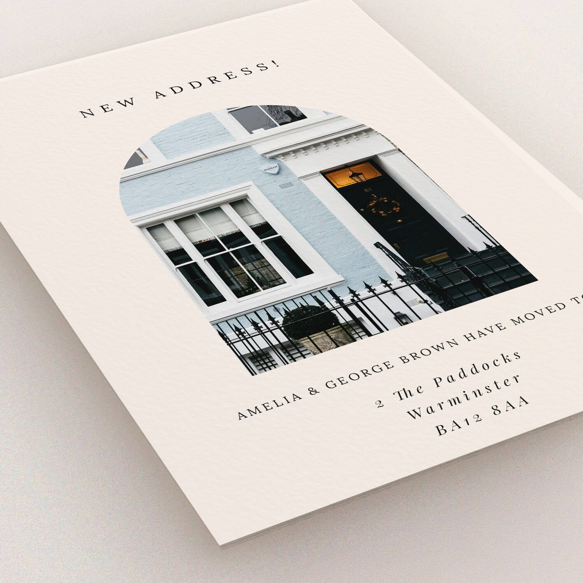 Change of address card design with arch-shaped photo of a house façade.