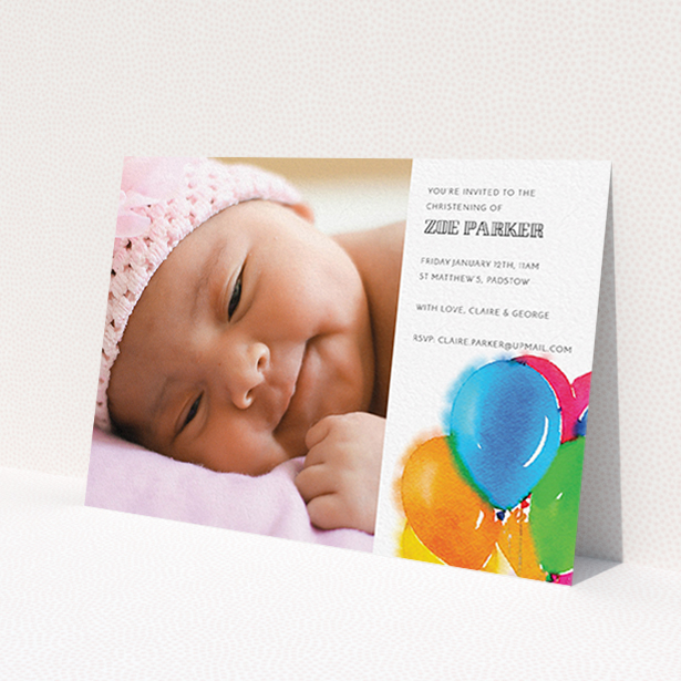 A christening invitation design called 'Big Balloons'. It is an A6 invite in a landscape orientation. It is a photographic christening invitation with room for 1 photo. 'Big Balloons' is available as a flat invite, with tones of white, orange and blue.