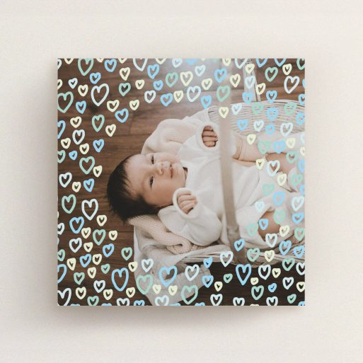 Christening Invitation Design - "Blue Hearts" A christening invitation design titled "Blue Hearts". It is a square (148mm x 148mm) invite in a square orientation. It is a photographic christening invitation with room for 1 photo. "Blue Hearts" is available as a flat invite, with mainly blue colouring.