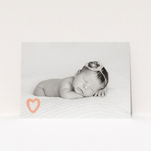 A christening invitation design titled "Pink heart motif". It is an A5 invite in a landscape orientation. It is a photographic christening invitation with room for 1 photo. "Pink heart motif" is available as a flat invite, with mainly light pink colouring.
