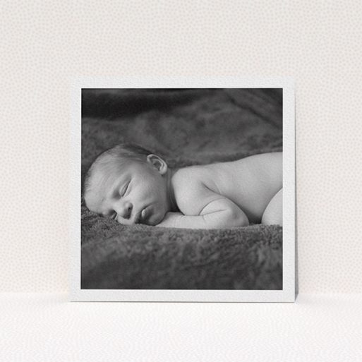 A christening invitation template titled "Thick White Framed Photo". It is a square (148mm x 148mm) invite in a square orientation. It is a photographic christening invitation with room for 1 photo. "Thick White Framed Photo" is available as a flat invite, with mainly white colouring.