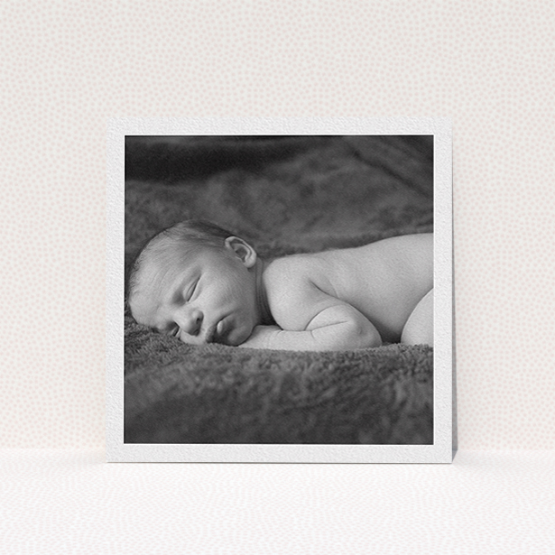 A christening invitation template titled "Thick White Framed Photo". It is a square (148mm x 148mm) invite in a square orientation. It is a photographic christening invitation with room for 1 photo. "Thick White Framed Photo" is available as a flat invite, with mainly white colouring.