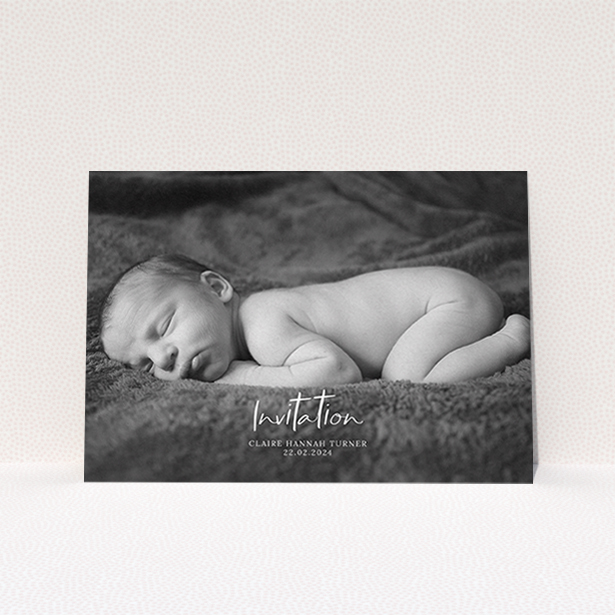 A christening invite design named "Central Script". It is an A6 invite in a landscape orientation. It is a photographic christening invite with room for 1 photo. "Central Script" is available as a flat invite, with mainly white colouring.