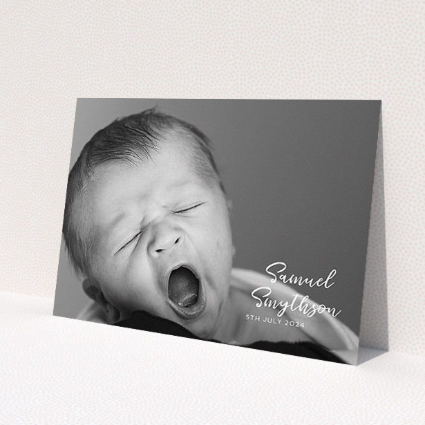 A christening invite design titled 'Soho Script'. It is an A5 invite in a landscape orientation. It is a photographic christening invite with room for 1 photo. 'Soho Script' is available as a flat invite, with mainly white colouring.