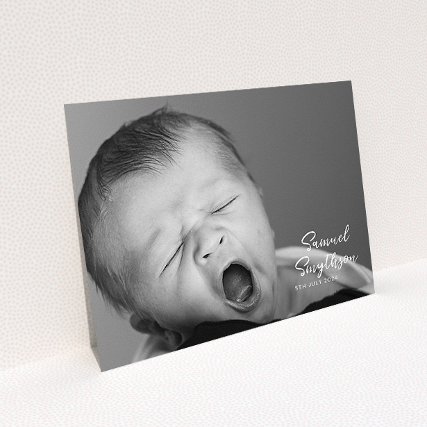 A christening invite design titled "Soho Script". It is an A5 invite in a landscape orientation. It is a photographic christening invite with room for 1 photo. "Soho Script" is available as a flat invite, with mainly white colouring.