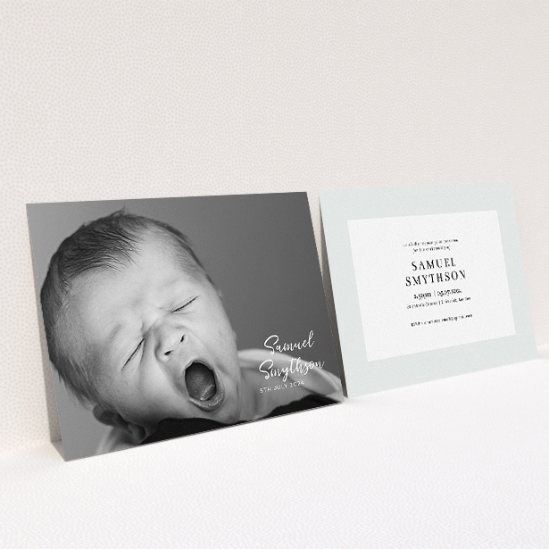 A christening invite design titled "Soho Script". It is an A5 invite in a landscape orientation. It is a photographic christening invite with room for 1 photo. "Soho Script" is available as a flat invite, with mainly white colouring.