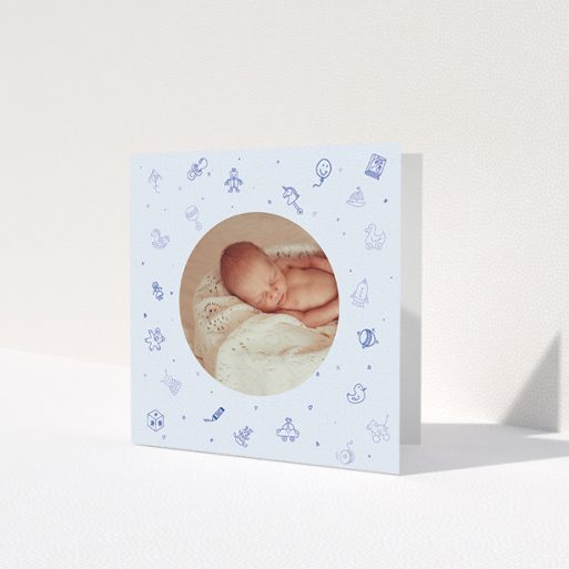 A christening thank you card named 'All the toys'. It is a square (148mm x 148mm) card in a square orientation. It is a photographic christening thank you card with room for 1 photo. 'All the toys' is available as a folded card, with mainly blue colouring.