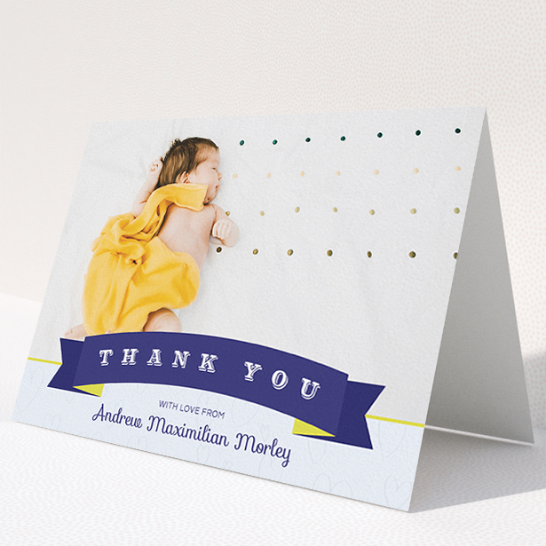 A christening thank you card named "Big Banner". It is an A5 card in a landscape orientation. It is a photographic christening thank you card with room for 1 photo. "Big Banner" is available as a folded card, with tones of blue, yellow and light blue.