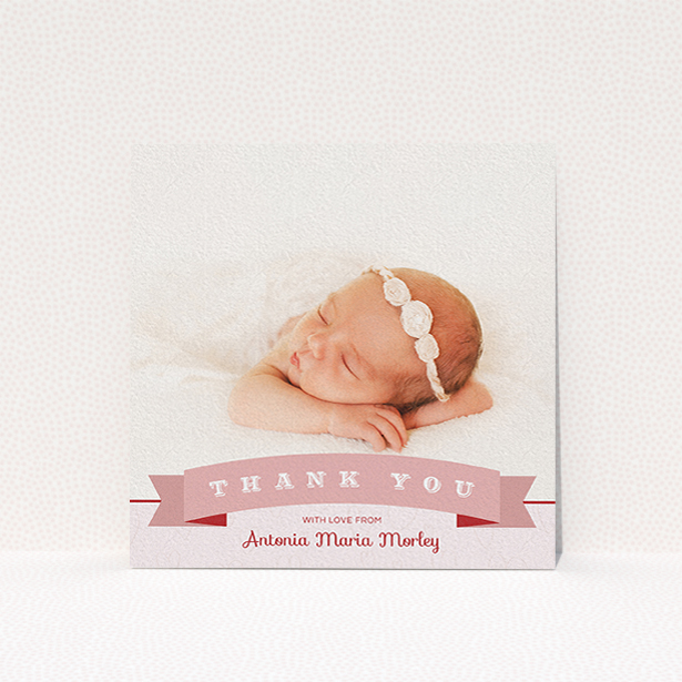 A christening thank you card design called "Big Banner". It is a square (148mm x 148mm) card in a square orientation. It is a photographic christening thank you card with room for 1 photo. "Big Banner" is available as a flat card, with tones of pink and white.