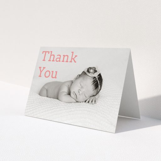 A christening thank you card design called 'Big Thanks'. It is an A5 card in a landscape orientation. It is a photographic christening thank you card with room for 1 photo. 'Big Thanks' is available as a folded card, with mainly light pink colouring.
