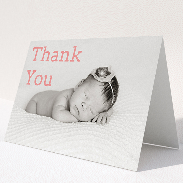 A christening thank you card design called "Big Thanks". It is an A5 card in a landscape orientation. It is a photographic christening thank you card with room for 1 photo. "Big Thanks" is available as a folded card, with mainly light pink colouring.