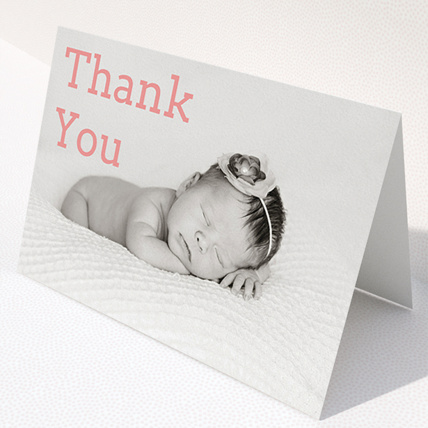 A christening thank you card design called "Big Thanks". It is an A5 card in a landscape orientation. It is a photographic christening thank you card with room for 1 photo. "Big Thanks" is available as a folded card, with mainly light pink colouring.