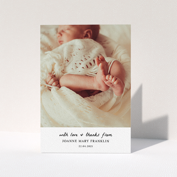 A christening thank you card design titled "Black and White Thanks". It is an A6 card in a portrait orientation. It is a photographic christening thank you card with room for 1 photo. "Black and White Thanks" is available as a folded card, with mainly white colouring.