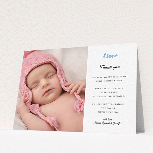 A christening thank you card design named "Blue Fern". It is an A5 card in a landscape orientation. It is a photographic christening thank you card with room for 1 photo. "Blue Fern" is available as a flat card, with tones of white and blue.