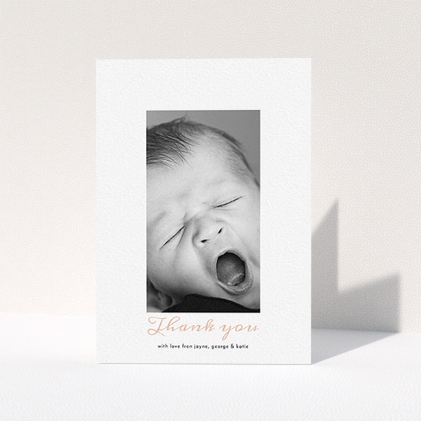 A christening thank you card design called "Central Portrait". It is an A6 card in a portrait orientation. It is a photographic christening thank you card with room for 1 photo. "Central Portrait" is available as a folded card, with tones of white and pink.