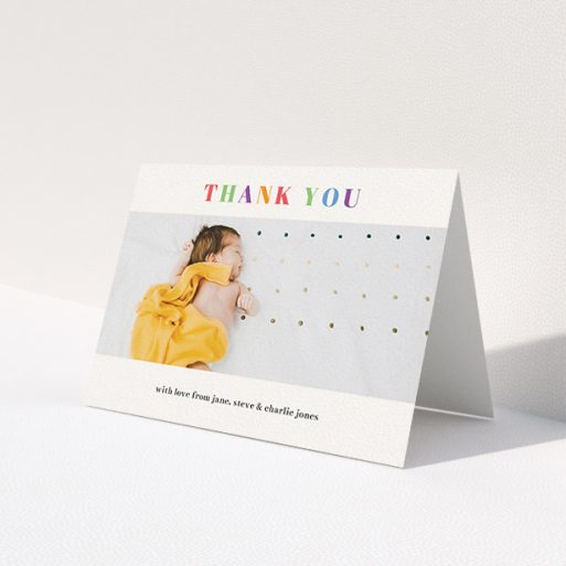 A christening thank you card design titled 'Colourful Thanks'. It is an A6 card in a landscape orientation. It is a photographic christening thank you card with room for 1 photo. 'Colourful Thanks' is available as a folded card, with tones of white and orange.