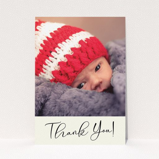 A christening thank you card design called "Cursive Thanks". It is an A5 card in a portrait orientation. It is a photographic christening thank you card with room for 1 photo. "Cursive Thanks" is available as a flat card, with mainly cream colouring.