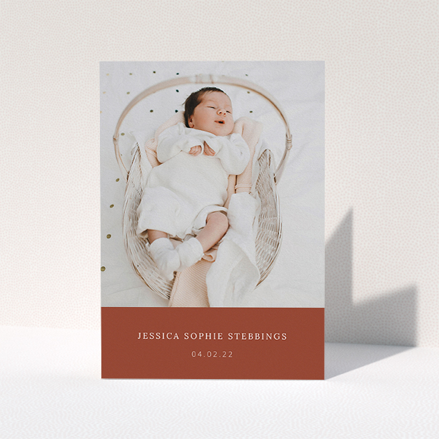 A christening thank you card design named "Dark Ochre Footer". It is an A5 card in a portrait orientation. It is a photographic christening thank you card with room for 1 photo. "Dark Ochre Footer" is available as a folded card, with mainly dark orange colouring.