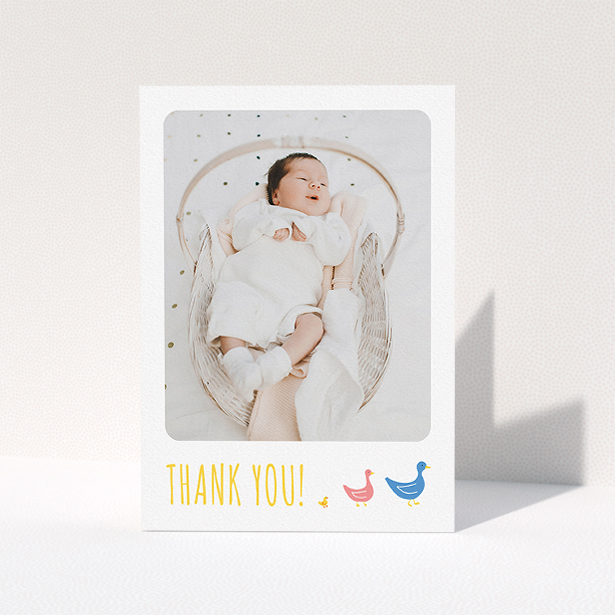 A christening thank you card named "Family of Ducks". It is an A5 card in a portrait orientation. It is a photographic christening thank you card with room for 1 photo. "Family of Ducks" is available as a folded card, with tones of yellow, blue and pink.