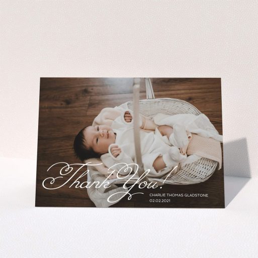 A christening thank you card called "Flourished Thank You". It is an A5 card in a landscape orientation. It is a photographic christening thank you card with room for 1 photo. "Flourished Thank You" is available as a folded card, with mainly white colouring.