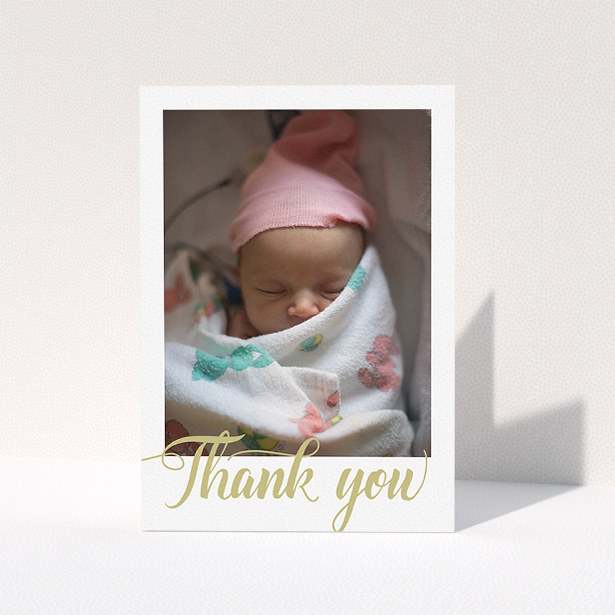 A christening thank you card design titled "Golden Thank You". It is an A5 card in a portrait orientation. It is a photographic christening thank you card with room for 1 photo. "Golden Thank You" is available as a folded card, with tones of white and gold.