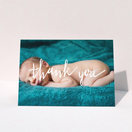 A christening thank you card design called "Handwritten Thanks". It is an A6 card in a landscape orientation. It is a photographic christening thank you card with room for 1 photo. "Handwritten Thanks" is available as a folded card, with mainly white colouring.