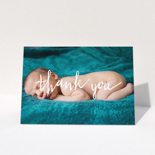 A christening thank you card design called "Handwritten Thanks". It is an A6 card in a landscape orientation. It is a photographic christening thank you card with room for 1 photo. "Handwritten Thanks" is available as a folded card, with mainly white colouring.