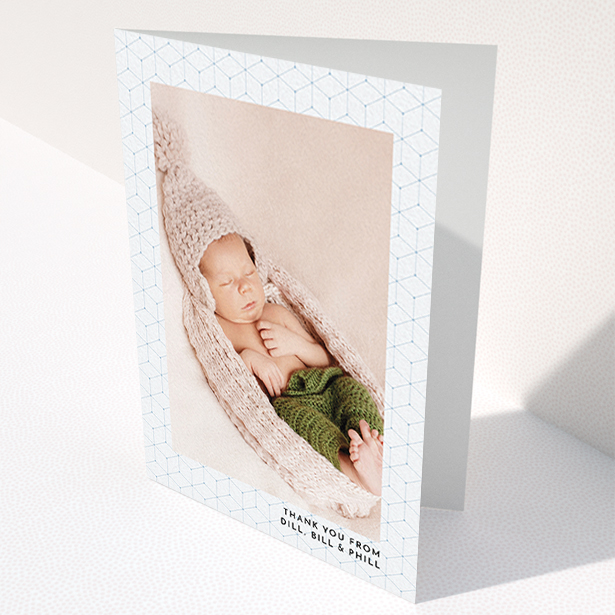 A christening thank you card called "Isometric Frame". It is an A6 card in a portrait orientation. It is a photographic christening thank you card with room for 1 photo. "Isometric Frame" is available as a folded card, with mainly blue colouring.