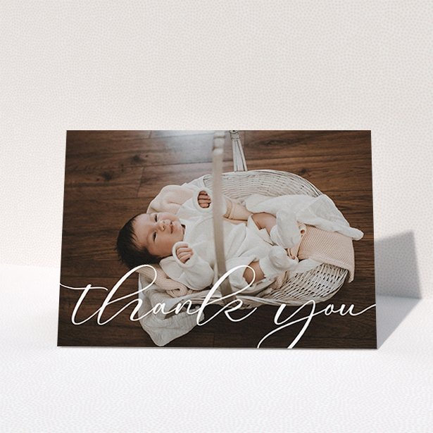 A christening thank you card design titled "One Photo". It is an A6 card in a landscape orientation. It is a photographic christening thank you card with room for 1 photo. "One Photo" is available as a folded card, with mainly white colouring.