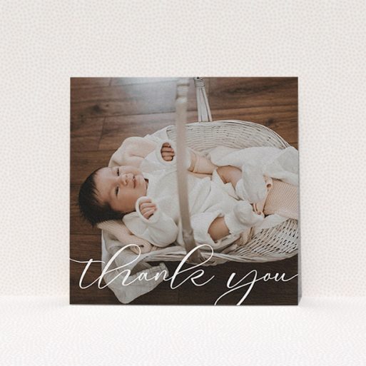 A christening thank you card template titled "One Photo". It is a square (148mm x 148mm) card in a square orientation. It is a photographic christening thank you card with room for 1 photo. "One Photo" is available as a flat card, with mainly white colouring.