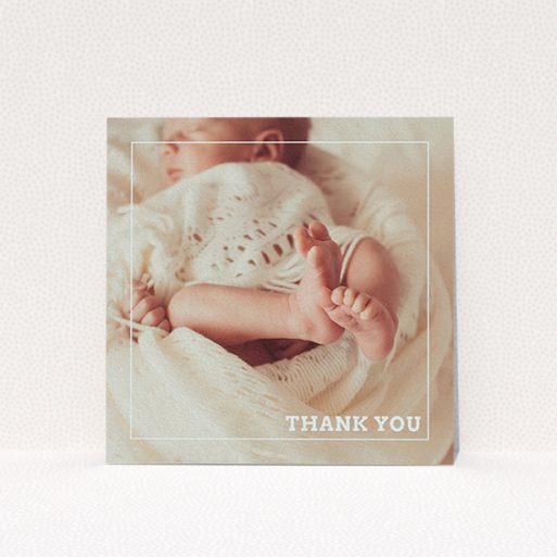 A christening thank you card template titled "Over Photo Frame". It is a square (148mm x 148mm) card in a square orientation. It is a photographic christening thank you card with room for 1 photo. "Over Photo Frame" is available as a flat card, with mainly pale pink colouring.