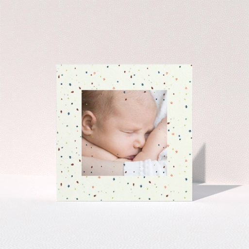 A christening thank you card template titled "Pastel Dots". It is a square (148mm x 148mm) card in a square orientation. It is a photographic christening thank you card with room for 1 photo. "Pastel Dots" is available as a folded card, with mainly light cream colouring.
