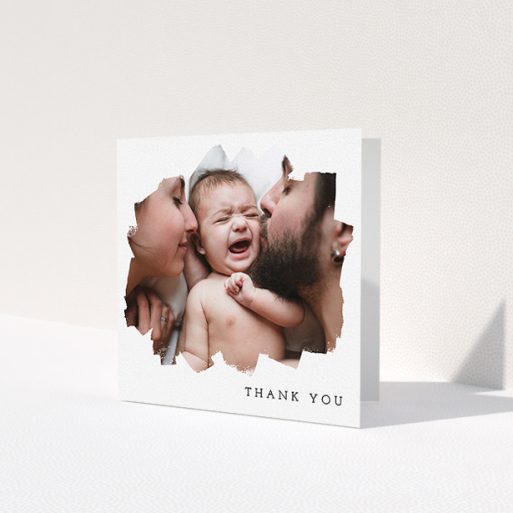 A christening thank you card named 'Scratched Banner'. It is a square (148mm x 148mm) card in a square orientation. It is a photographic christening thank you card with room for 1 photo. 'Scratched Banner' is available as a folded card, with mainly white colouring.