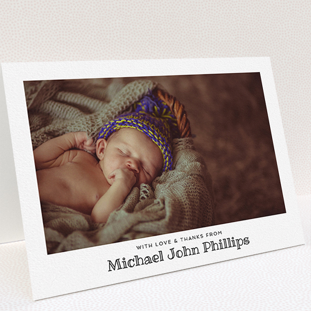 A christening thank you card named "Simple Photo Frame". It is an A5 card in a landscape orientation. It is a photographic christening thank you card with room for 1 photo. "Simple Photo Frame" is available as a folded card, with mainly white colouring.