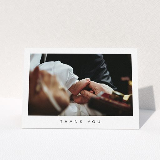 A christening thank you card design named "Simple Thanks". It is an A5 card in a landscape orientation. It is a photographic christening thank you card with room for 1 photo. "Simple Thanks" is available as a folded card, with mainly white colouring.