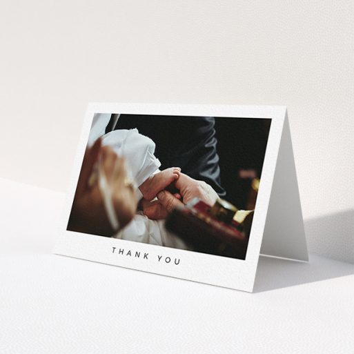 A christening thank you card template titled 'Simple Thanks'. It is an A6 card in a landscape orientation. It is a photographic christening thank you card with room for 1 photo. 'Simple Thanks' is available as a folded card, with mainly white colouring.