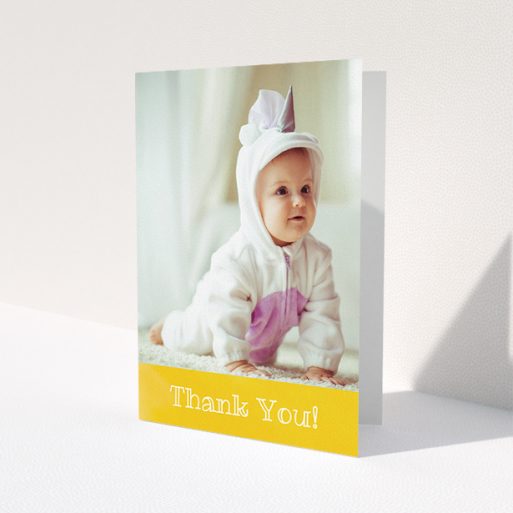 A christening thank you card named 'Thanks In Yellow'. It is an A5 card in a portrait orientation. It is a photographic christening thank you card with room for 1 photo. 'Thanks In Yellow' is available as a folded card, with tones of yellow and white.