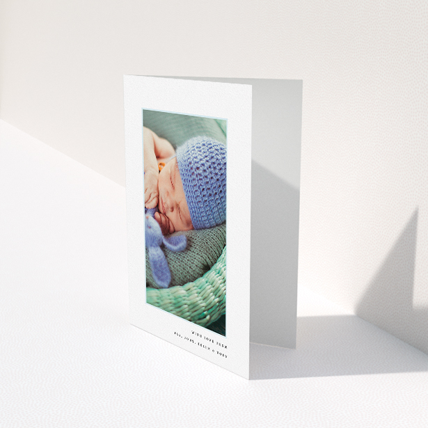 A christening thank you card named "Thin Blue Frame". It is an A5 card in a portrait orientation. It is a photographic christening thank you card with room for 1 photo. "Thin Blue Frame" is available as a folded card, with tones of white and blue.