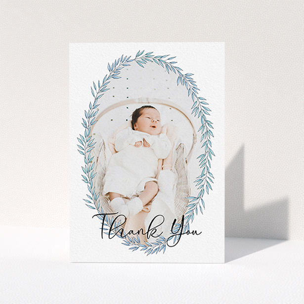 A christening thank you card design titled "Tussled Wreath". It is an A6 card in a portrait orientation. It is a photographic christening thank you card with room for 1 photo. "Tussled Wreath" is available as a folded card, with tones of blue and white.