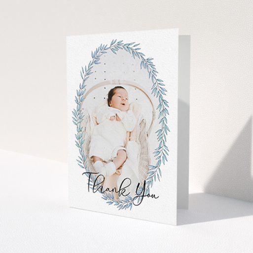 A christening thank you card design titled 'Tussled Wreath'. It is an A6 card in a portrait orientation. It is a photographic christening thank you card with room for 1 photo. 'Tussled Wreath' is available as a folded card, with tones of blue and white.