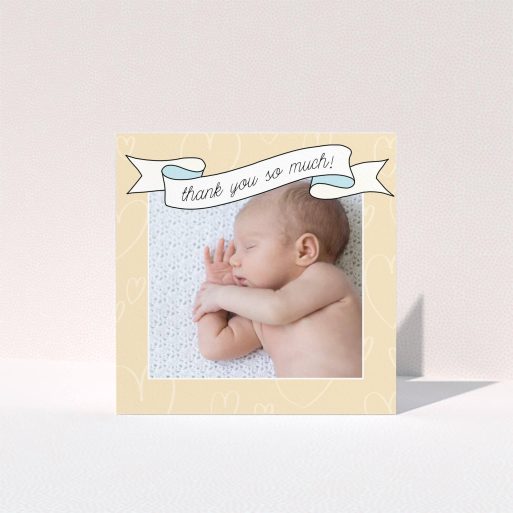 A christening thank you card design titled "Written Above". It is a square (148mm x 148mm) card in a square orientation. It is a photographic christening thank you card with room for 1 photo. "Written Above" is available as a folded card, with tones of faded yellow and light blue.