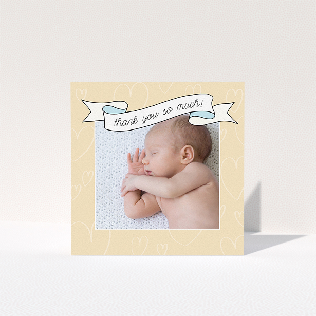 A christening thank you card design titled "Written Above". It is a square (148mm x 148mm) card in a square orientation. It is a photographic christening thank you card with room for 1 photo. "Written Above" is available as a folded card, with tones of faded yellow and light blue.
