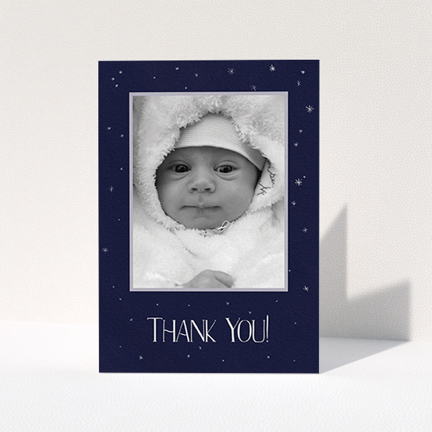 A christening thank you card template titled "Written in the Stars". It is an A6 card in a portrait orientation. It is a photographic christening thank you card with room for 1 photo. "Written in the Stars" is available as a folded card, with tones of dark blue, white and silver.