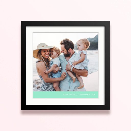 Framed and mounted photo print with a family of four on the beach.