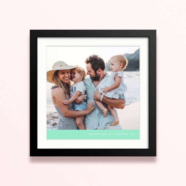 Framed and mounted photo print with a family of four on the beach.